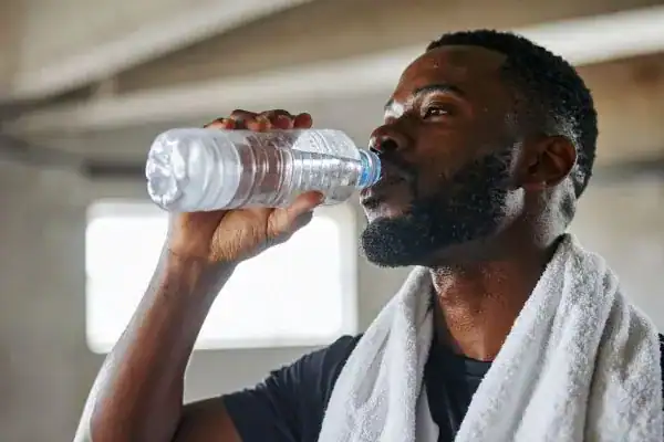 Image of man drinking water to improve hydration Eastleigh  after work out.